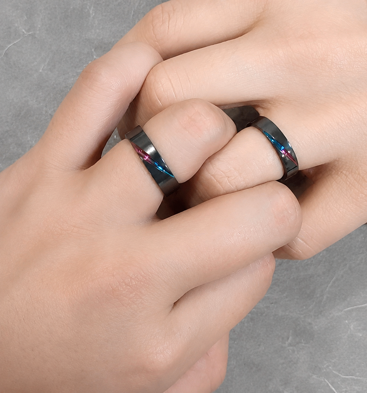 発色を施した黒い結婚指輪を着けたふたりの手元