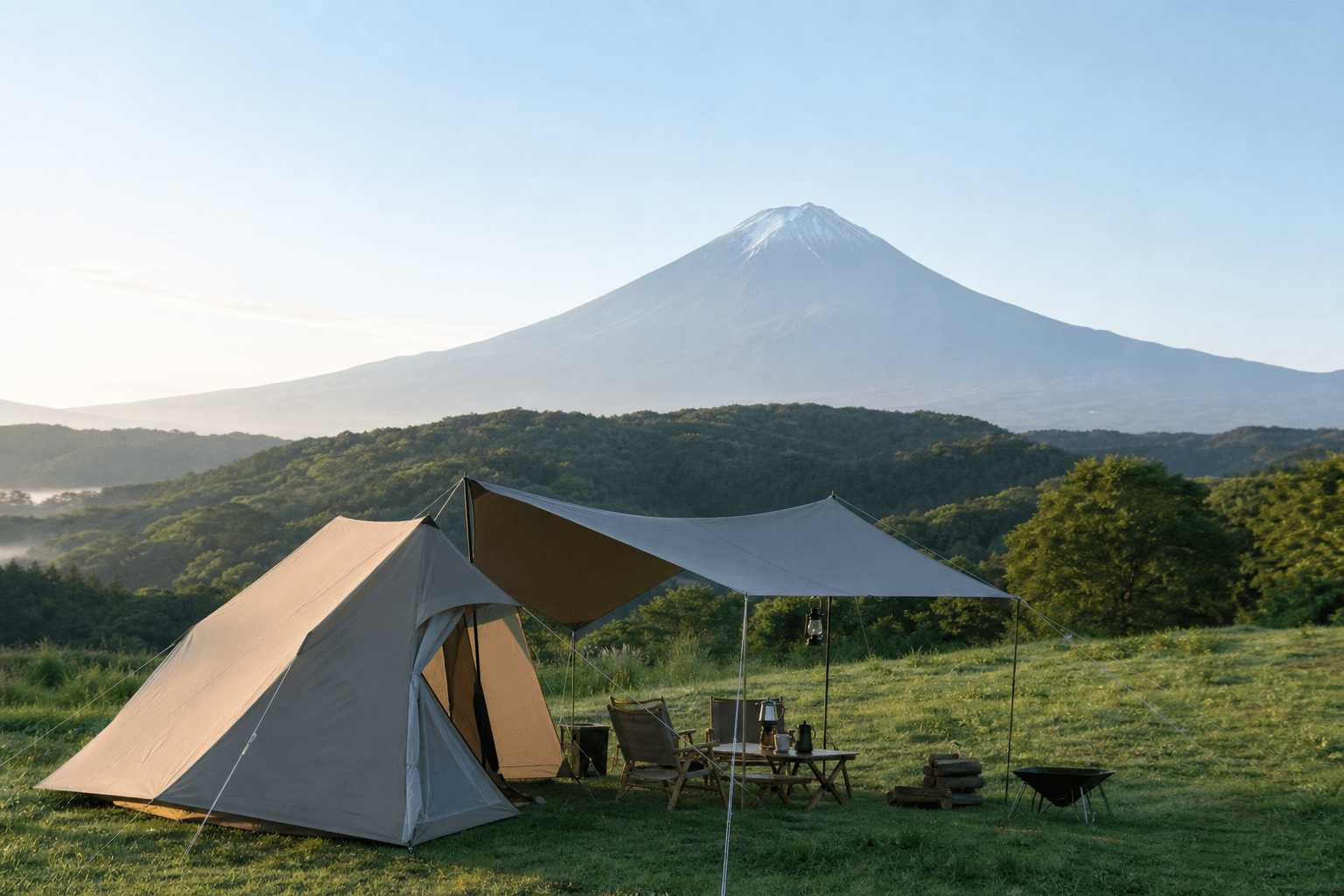 山を望むキャンプ場に設営されたテントとタープ